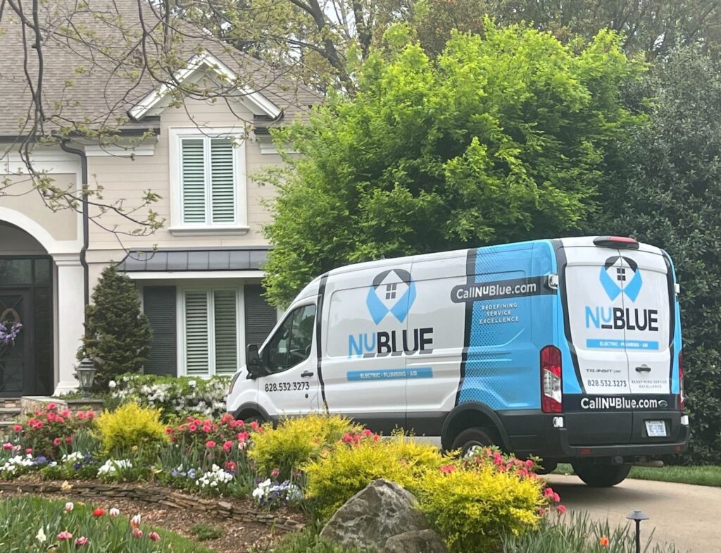 NuBlue Service Group van parked in front of large home.