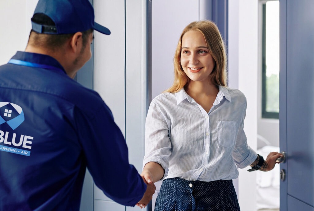 NuBlue employee greeting homeowner