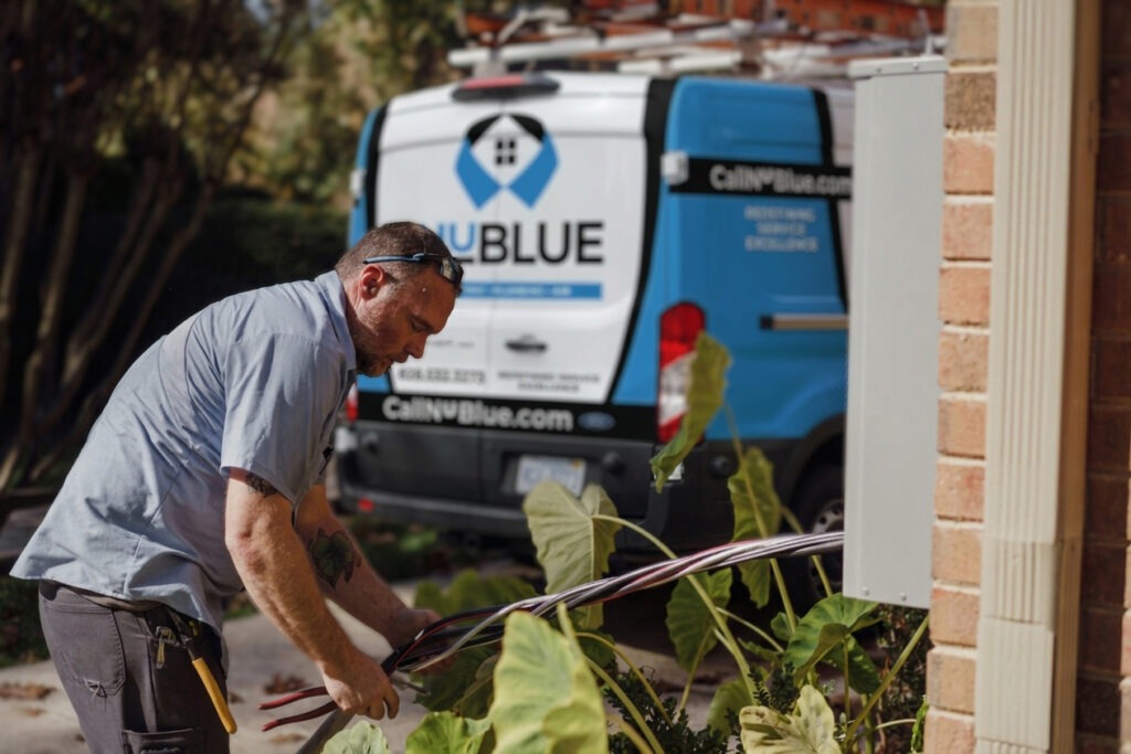 A man working outside near a NuBlue van